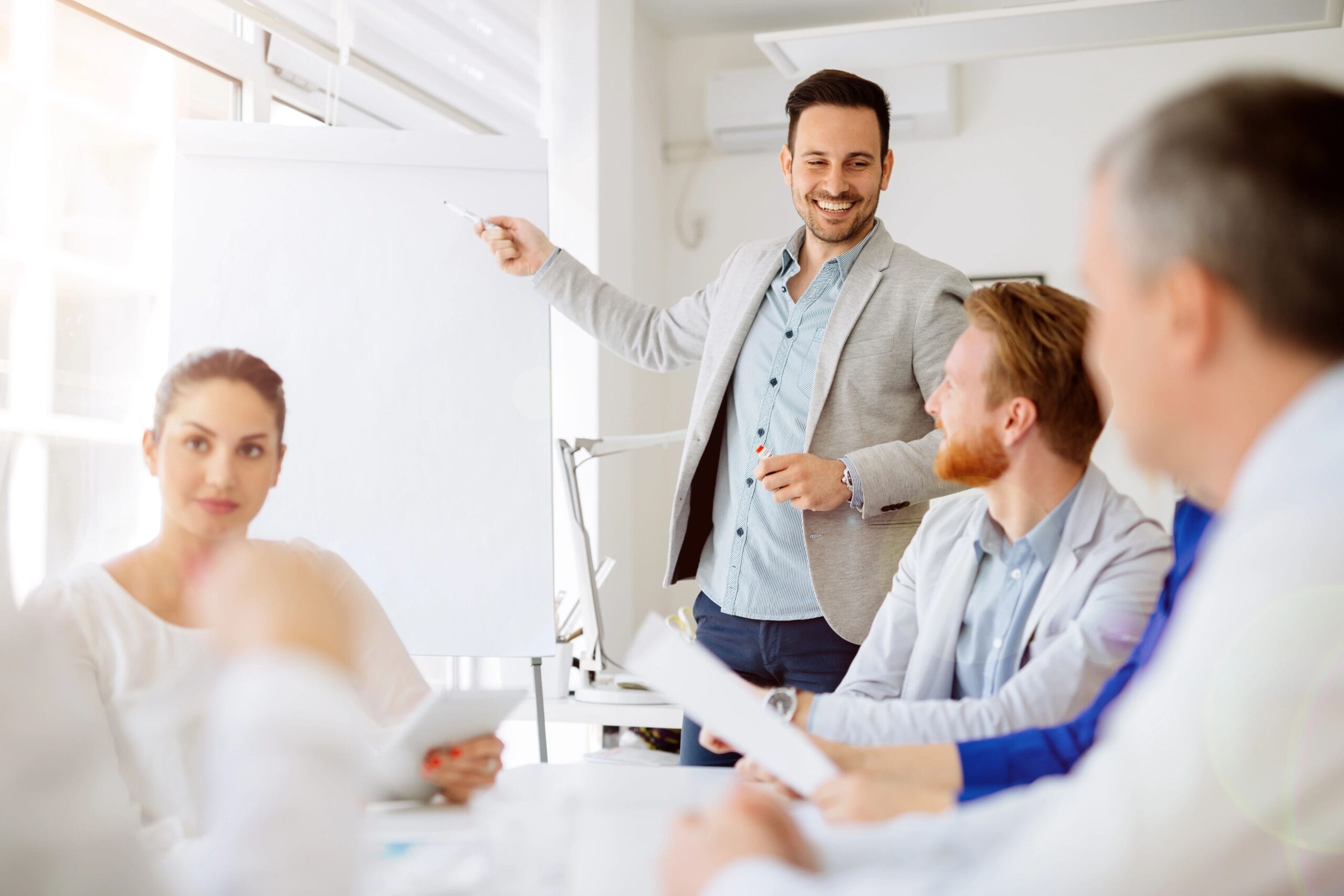 Präsentationstraining für Führungskräfte: Führungskraft präsentiert am Flipchart vor Team